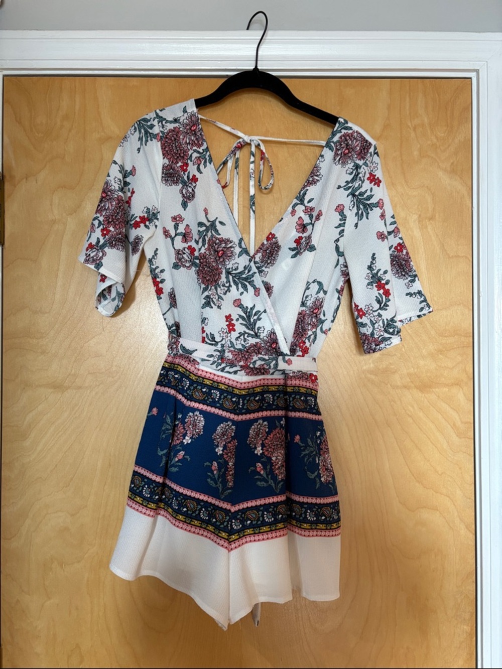 Floral V-Neck Short Sleeve Romper in White and Navy Francesca’s